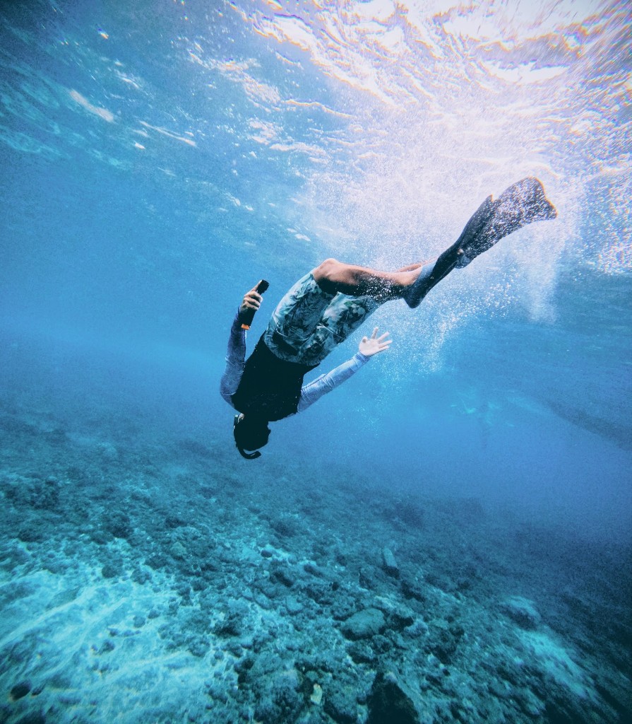 Freediving underwater in clear blue ocean